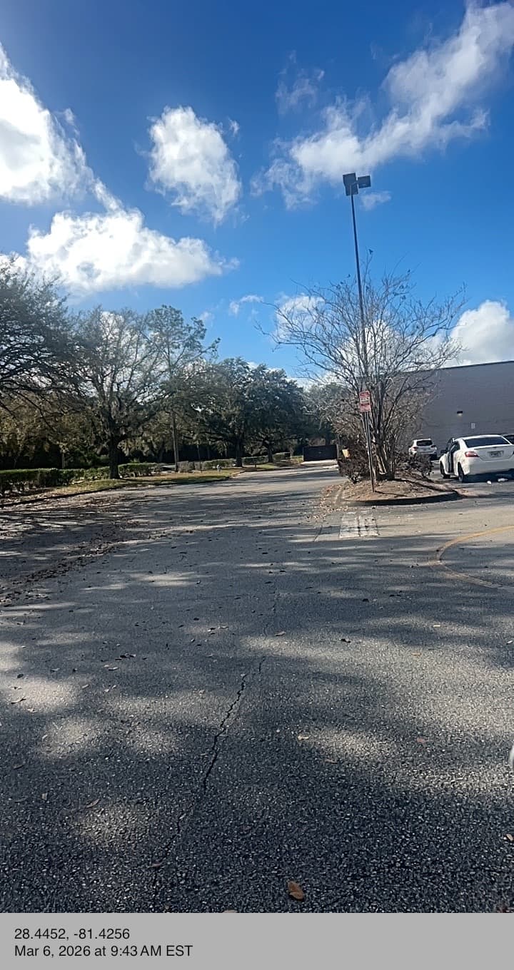 Commercial lot debris cracked pavement property cleanup Central Florida